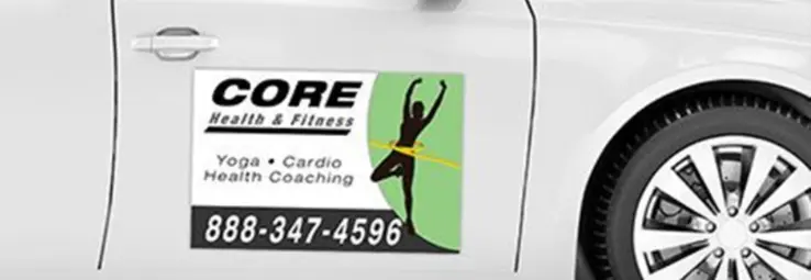 A fitness car magnet on a white car.