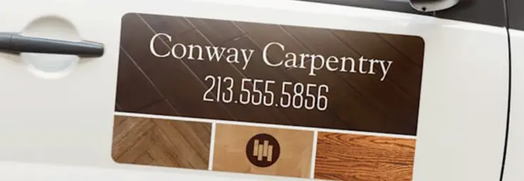 A car magnet advertising a carpenter on a white car.