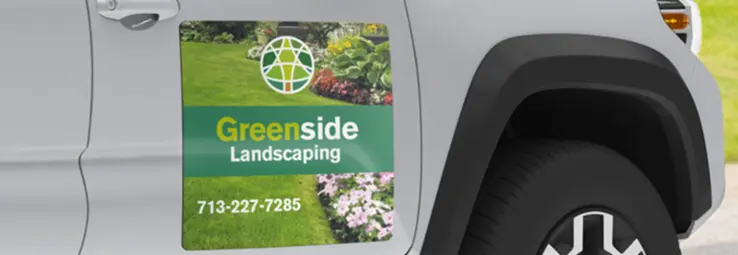 A Landscaping company advertising with a car magnet.