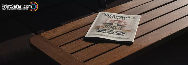 A travel brochure laying on a wooden bench.