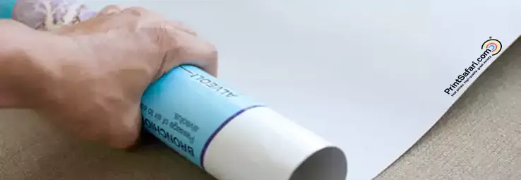 Two hands rolling a poster.