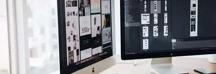 Two displays working in graphic design software.