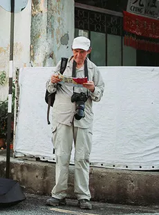 A tourist looking at a travel brochure