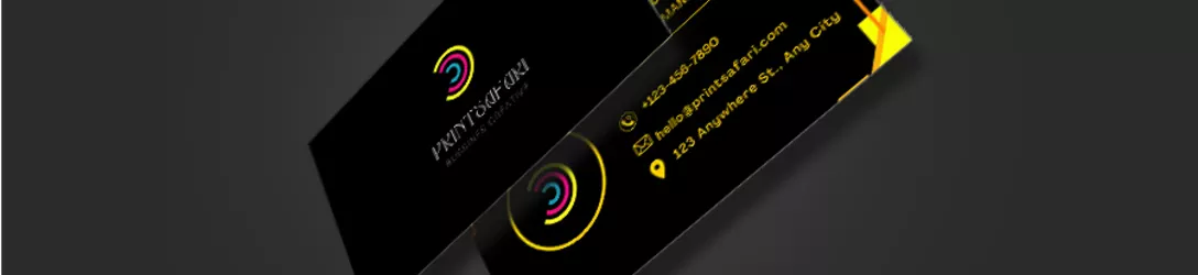 A sleek black business card featuring a bold and vibrant Printsafari logo in yellow and cyan, creating a striking contrast against the dark background.