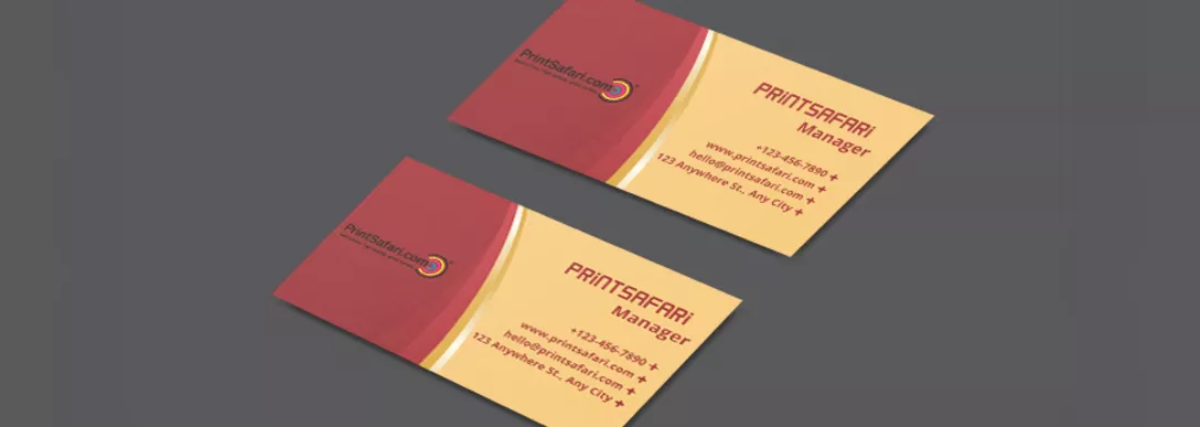 Two elegant business cards on a table, one card featuring a deep, rich red on the left side and a soft sand color on the right, representing the manager of Printsafari with a sophisticated and professional design.
