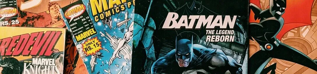 A collection of comics in various sizes, featuring dynamic covers and a mix of superhero and noir-style themes.