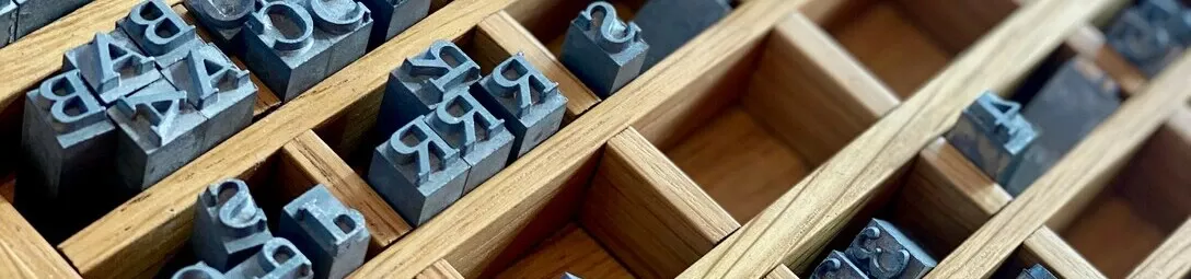 Printing letters in molds used for printing, with the small letters being individual stamps.