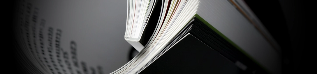 Perfect bound booklet opened on a table.