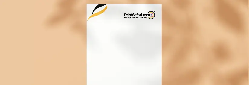 A customized letterhead laying on top of an orange surface.