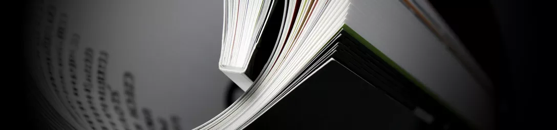 Perfect bound booklet opened on a table.