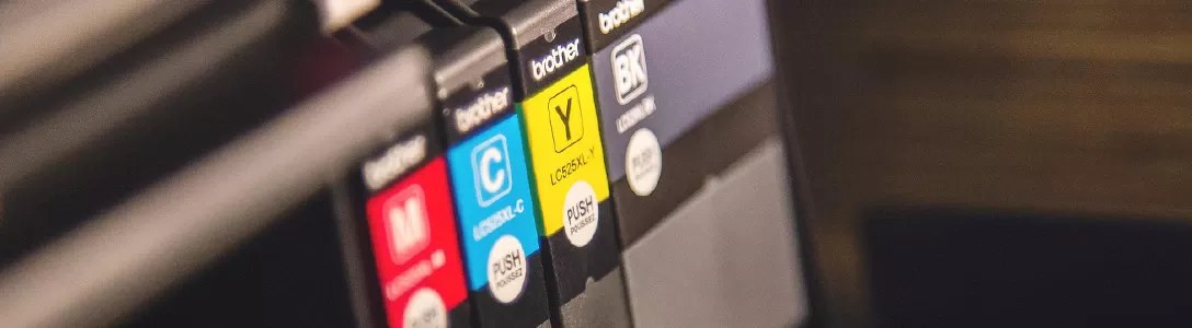 Image of a printer's loading tray with four different CMY(K) color cartridges, each color stored in a separate cartridge.
