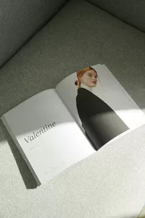 An opened magazine laying flat on the ground.
