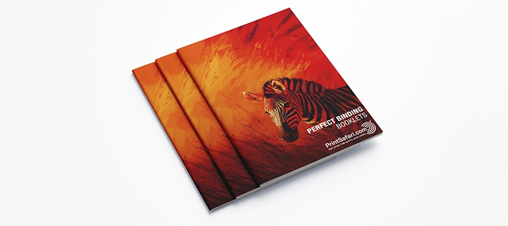 Three perfect binding booklets featuring a zebra design on the cover, showcasing a sleek and professional appearance.