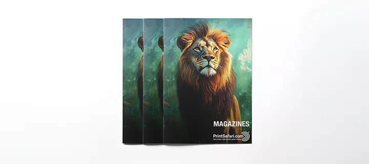 Three magazines in a row with the cover facing up; the cover has a green background, featuring a male lion staring directly into the camera.