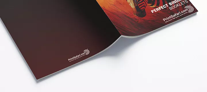 An open perfect binding booklet lying on a table with the binding facing up, showcasing the interior pages and high-quality craftsmanship.