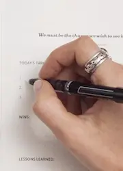 Close-up of a hand checking off items on a checklist, symbolizing organization and task completion.