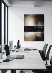 Modern office meeting room with a large abstract painting on the wall, computers on a long table, and chairs.