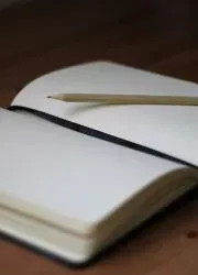 Open journal with pencil