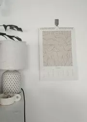 Modern wall calendar with artistic design in minimal home setting