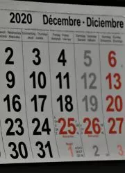 Monthly grid view showing December dates with holidays highlighted in red