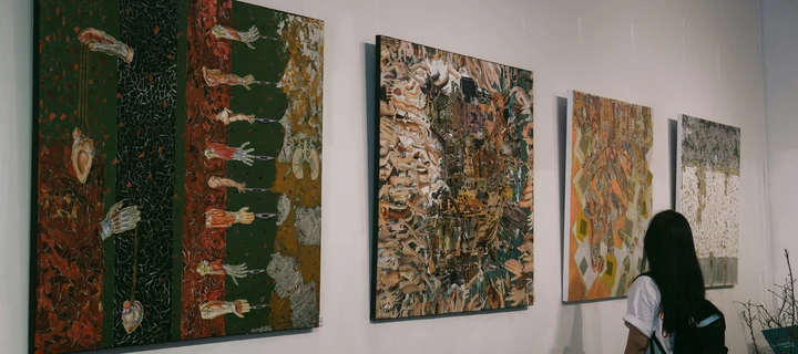 Person looking at mounted wall prints