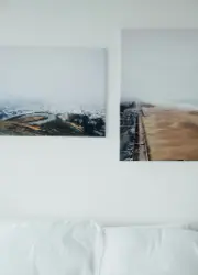 Mounted wall print hanging above a bed