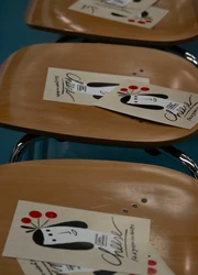 Chairs with flyers lying on them.