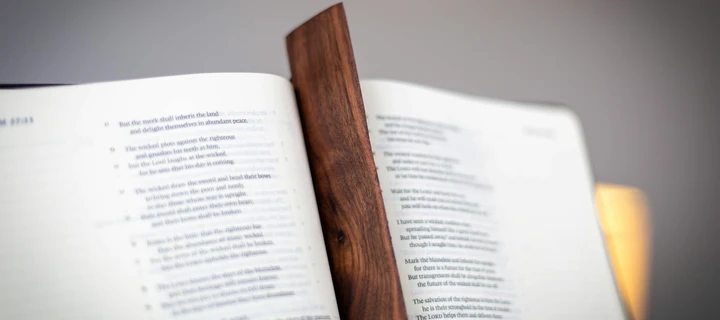 A book with a wooden bookmark inside of it