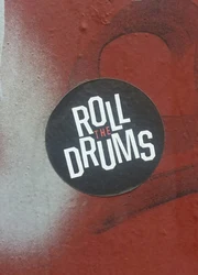 Custom round label sticking on a graffiti wall