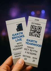 A hand holding two tickets.
