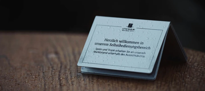 Layered folded business cards standing on an outside table