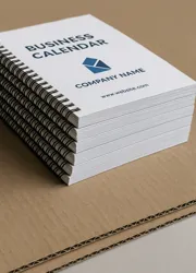 Stack of custom spiral-bound business calendars with company branding, ready for distribution.  Bild 2 (Mitte):