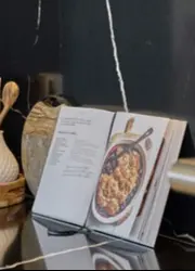 An open cookbook in the kitchen.