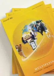 Close-up of several opened magazines stacked on top of each other, showcasing colorful pages and diverse layouts.