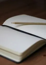 Open journal with pencil