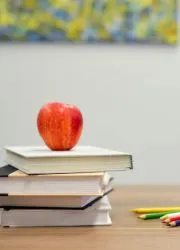 School yearbooks stacked on a desk