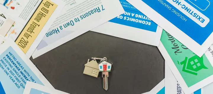 Key surrounded by Flyers laying on a flat surface