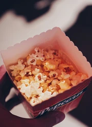 A top-down view of a popcorn box filled with popcorn