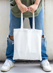 A person holding a Canvas Bag with two hands