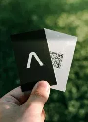 Black and white business card featuring modern QR code design