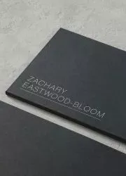 Elegant matte black business card with embossed lettering