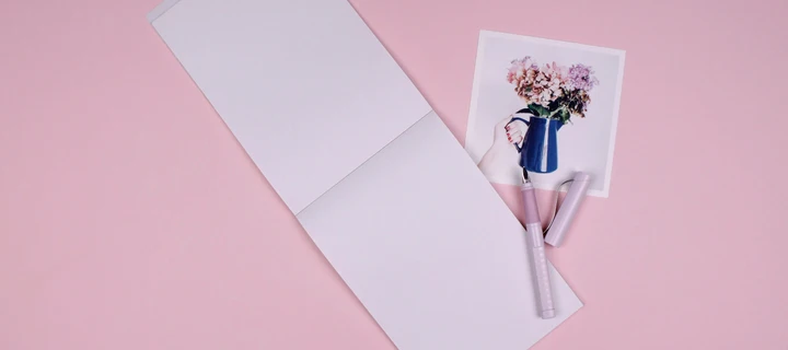 An open notepad with a fountain pen on it