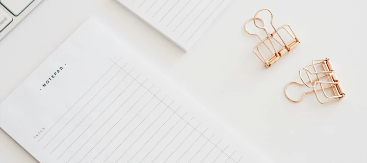 A lined notepad on a white surface
