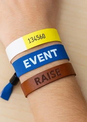Various wristband types including Tyvek, fabric, and leather displayed on a wrist
