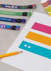 Designer’s workspace with colorful wristbands and design tools, no visible text