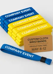 A stack of neatly printed Tyvek wristbands next to a recycling bin and eco-friendly packaging.