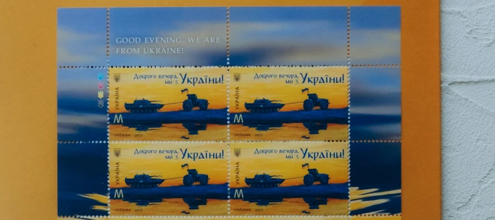 A coupon flyer on an orange surface.