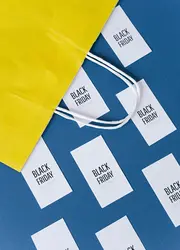 Coupons coming out of a yellow bag.