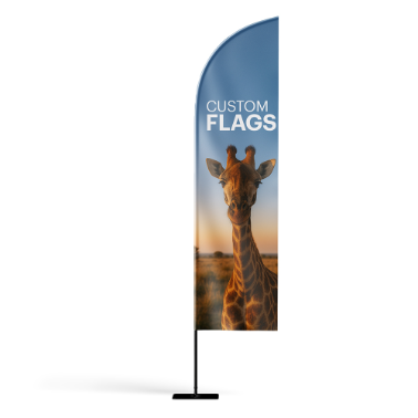 Custom feather flag with a giraffe against a sunrise background and the text custom flags, displayed on a flat black base.