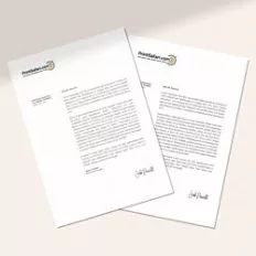 Stack of custom letterheads with minimalist black text and color markers at the bottom, held together with black clips, accompanied by two yellow pencils on a white surface.